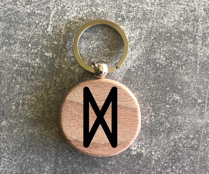 Round wooden keychain with the Elder Futhark rune "DAGAZ"