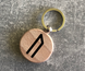 Round wooden keychain with the Elder Futhark rune "Uruz"